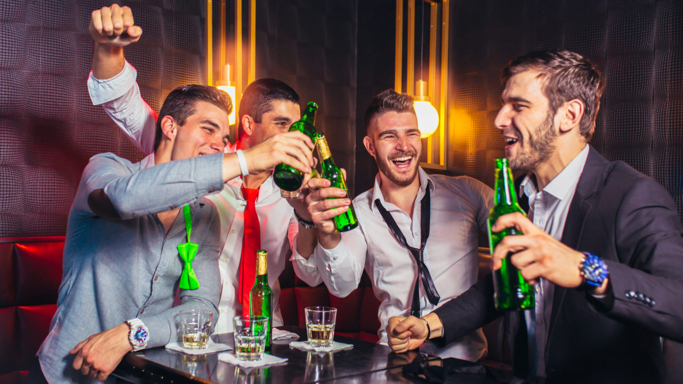 Group of young men toasting at a nightclub