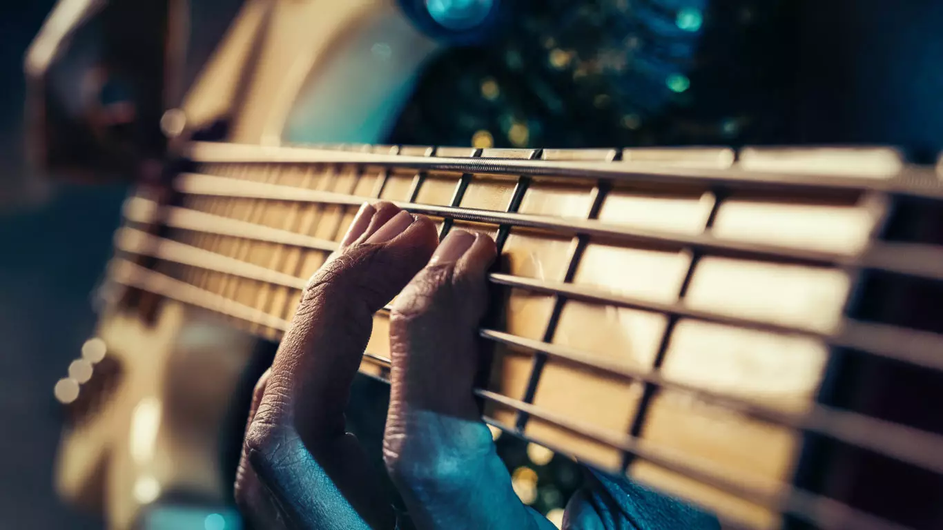 Closeup photo of bass guitar player hands