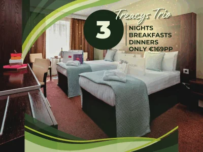 Hotel room with two double beds, modern decor, and a window. Promotional text offers 3 nights, breakfasts, and dinners for €169 per person at Treacys Trio.