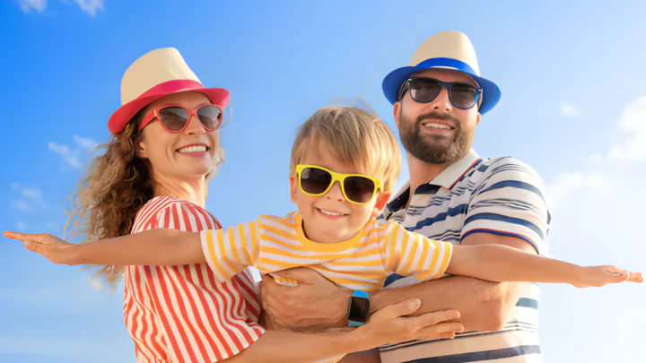 Happy family enjoying a sunny beach day, perfect for relaxation and fun at a seaside hotel. Family-friendly amenities await.