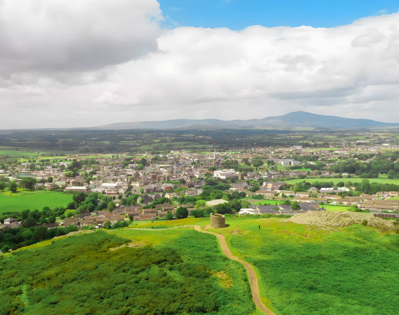 Breathtaking hilltop view of lush countryside and historic town near the hotel, perfect for nature walks and cultural exploration.