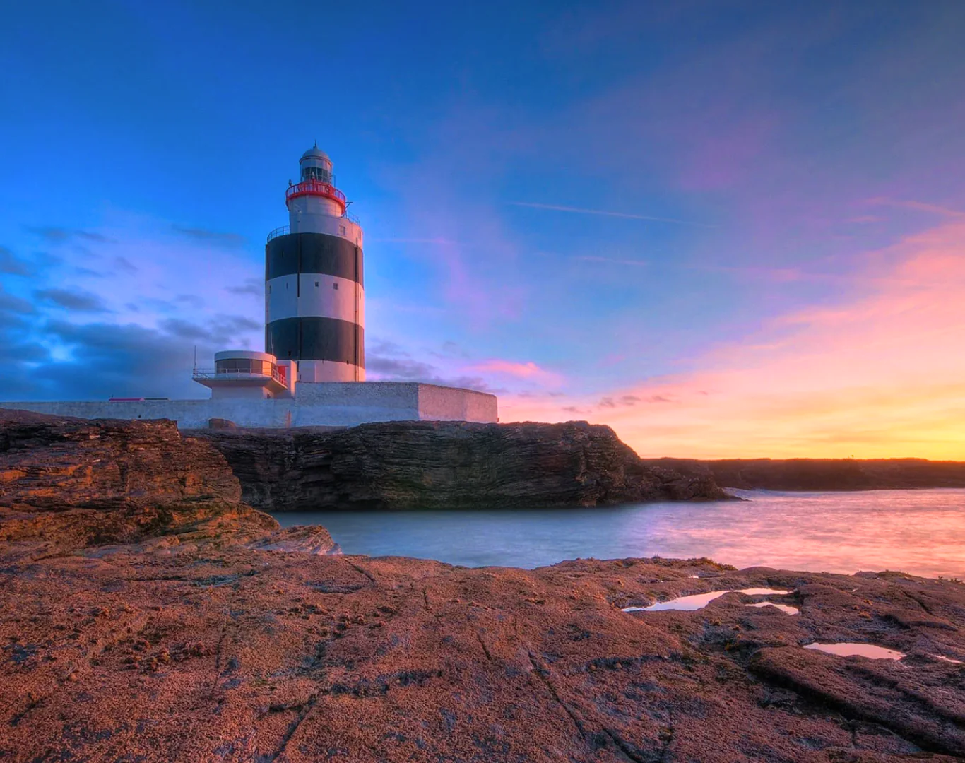 Stunning lighthouse at sunset with ocean views, perfect for a serene seaside escape. Ideal for relaxation and photography.