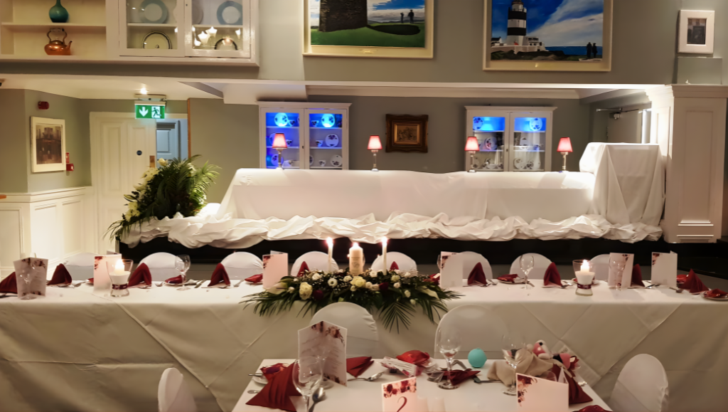 Elegant hotel dining room with candlelit tables, cosy seating, and artistic decor, perfect for events and celebrations.