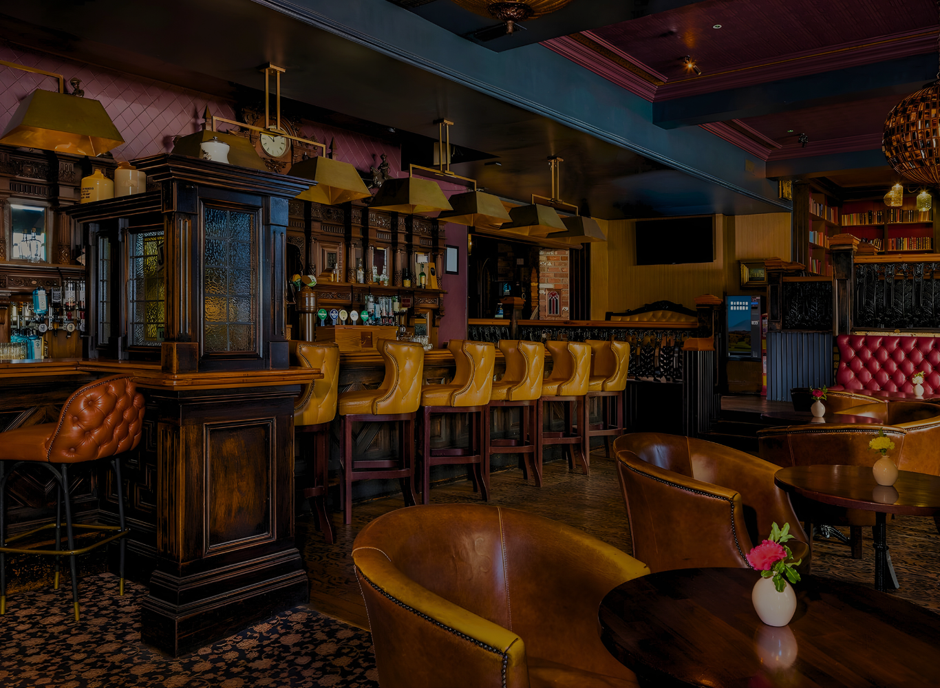 Cozy hotel bar with plush leather chairs, elegant wooden decor, and a welcoming atmosphere for relaxation and socialising.