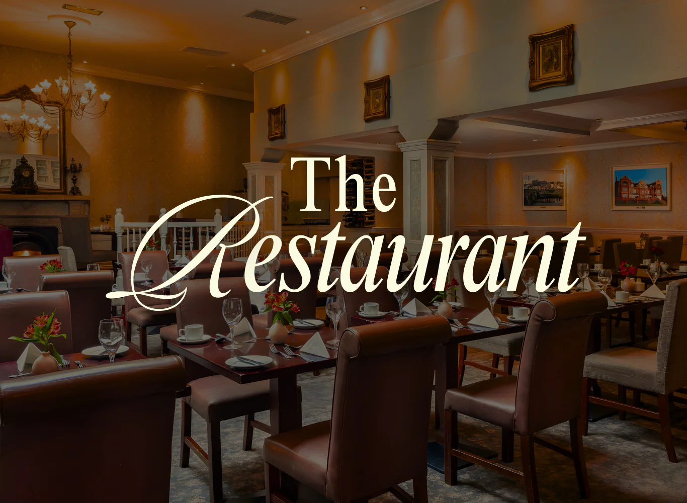 Elegant hotel restaurant with cosy seating, chandelier lighting, and beautifully set tables, perfect for fine dining.