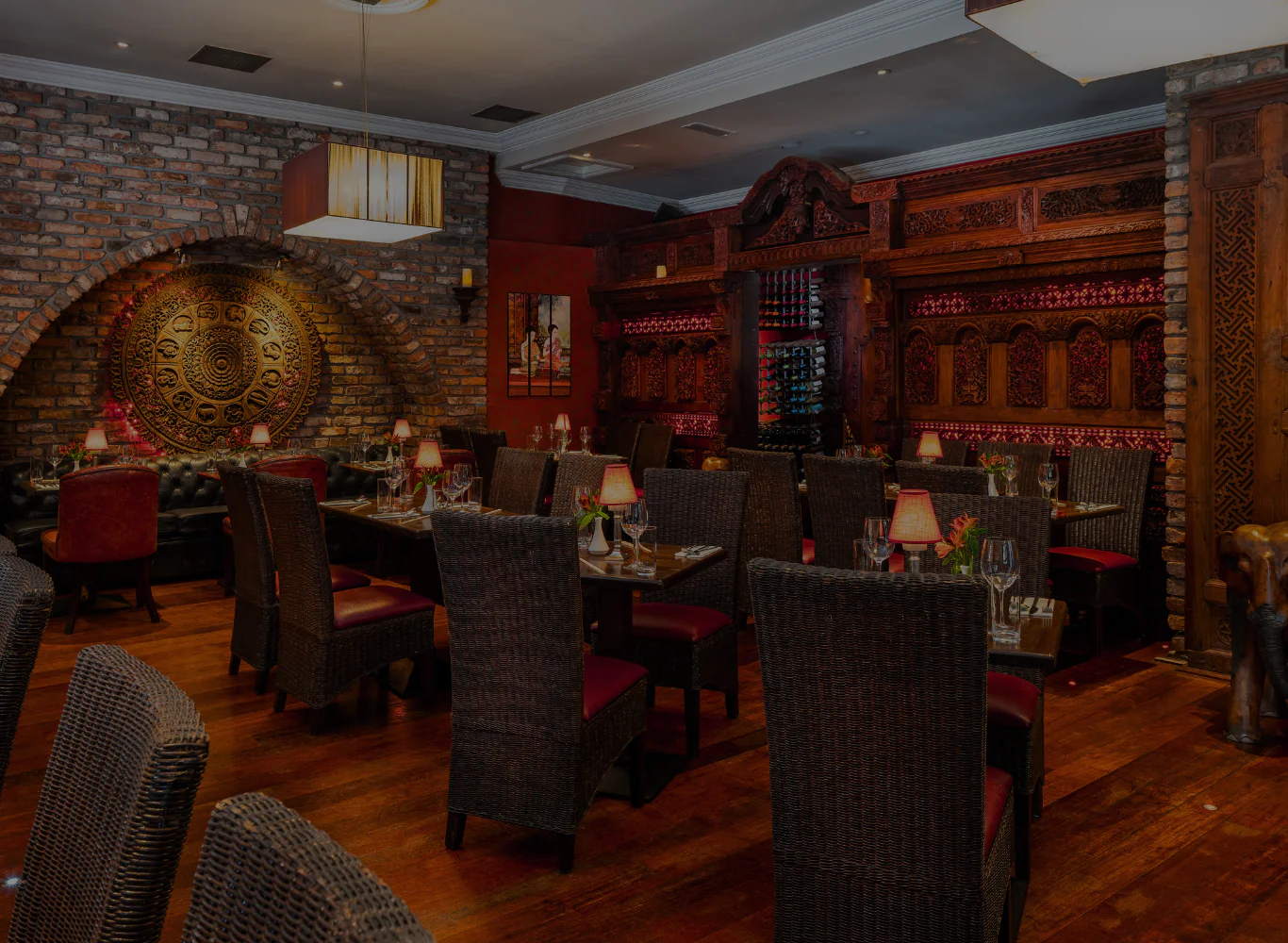 Luxurious hotel dining room with elegant décor, ambient lighting, plush seating, and exquisite wooden accents for a fine dining experience.
