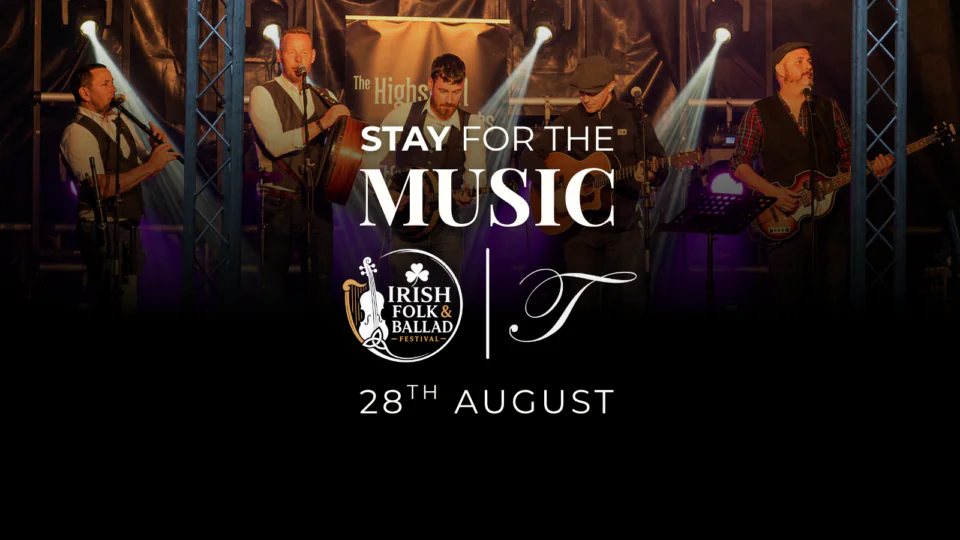 Guests enjoy lively Irish folk music performance under cosy tent lighting, enhancing a vibrant festival atmosphere.